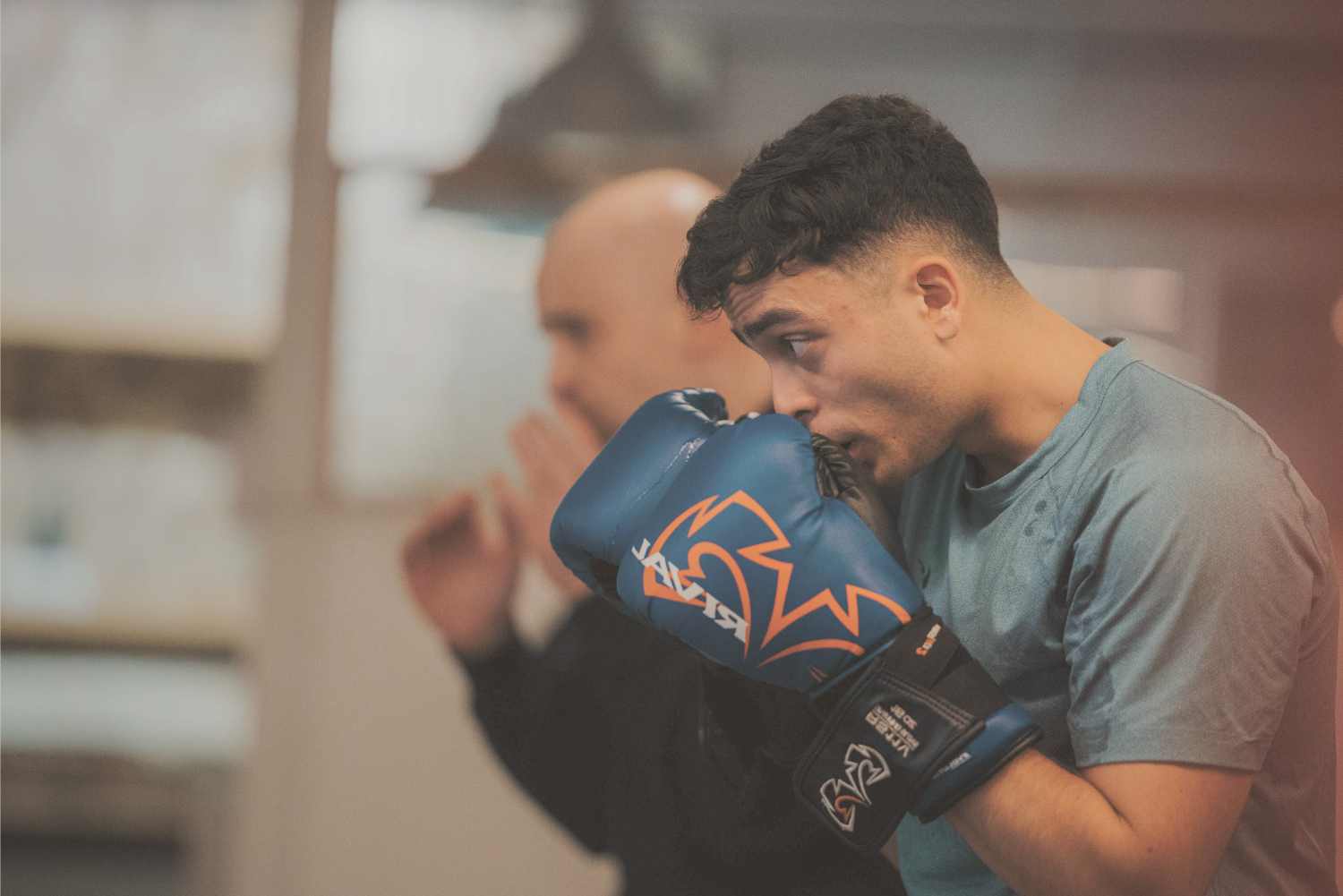 beginner-boxing-taster-session-coaching-fighterfit-london Beginner learning boxing basics with a coach during a taster session at FighterFit London.